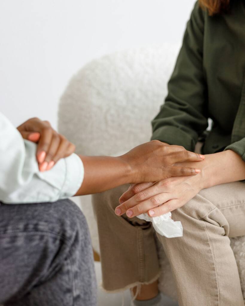 mental support to hold hands, handshake. An African-American female psychologist holds an